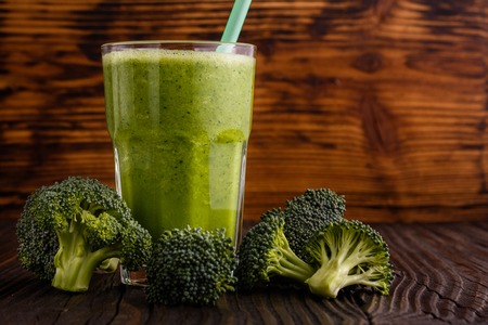 fresh broccoli juice on a wooden background.の写真素材