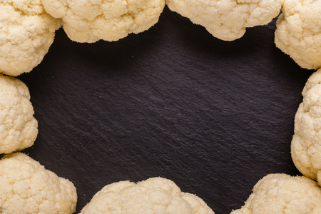 fresh cauliflower on a dark stone background.の写真素材
