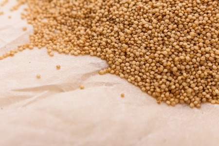 fresh amaranth grains on a rustic background.