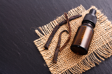 vanilla essential oil on a dark background.の写真素材