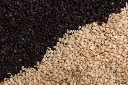 fresh sesame seeds on a rustic background.の写真素材