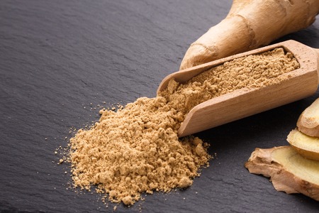 Ginger root on a dark stone background.