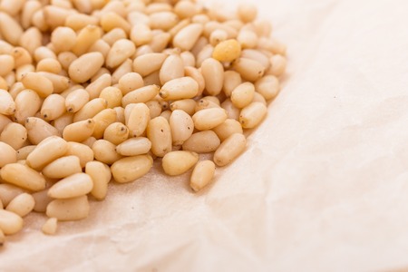 peeled pine nuts on a rustic background.の写真素材