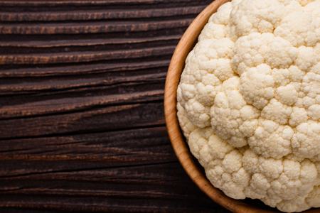 fresh cauliflower on a rustic wooden background.の写真素材