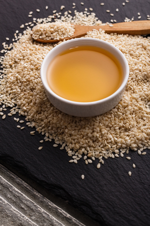 fresh sesame seeds on a rustic background.の写真素材