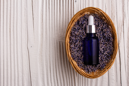 Lavender essential oil on a wooden background.の写真素材