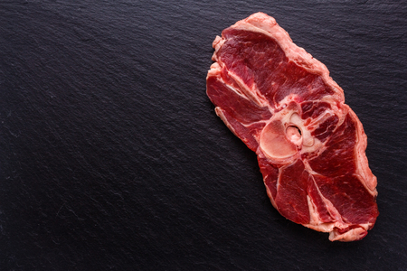 fresh lamb meat on a textured stone plate.の写真素材