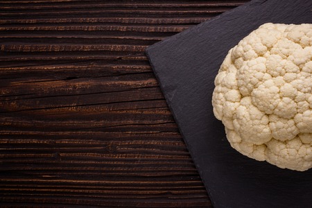 fresh cauliflower on a rustic wooden background.の写真素材