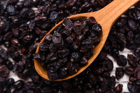dried barberry berries on the rustic background.の写真素材
