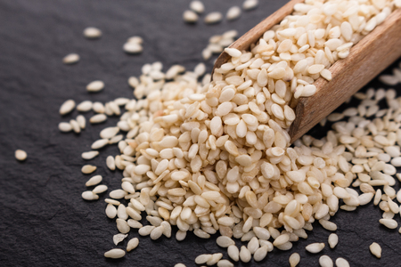 fresh sesame seeds on a rustic background.の写真素材