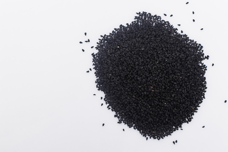 grains of black cumin and oil on the rustic background.の写真素材