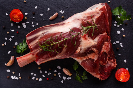 fresh lamb meat on a textured stone plate.の写真素材