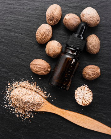 nutmeg essential oil on a dark stone background.の写真素材