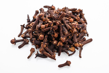 fragrant cloves on a white acrylic background.の写真素材