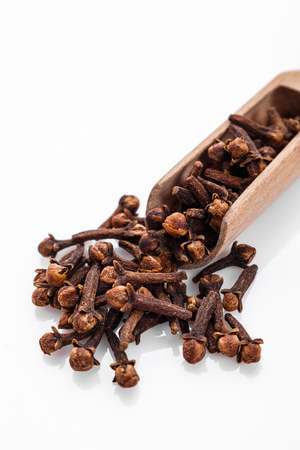 fragrant cloves on a white acrylic background.の写真素材