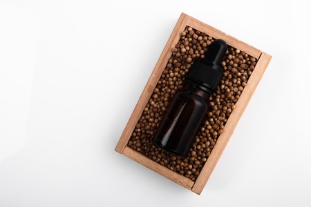 coriander seeds on a white background, essential oil.の写真素材