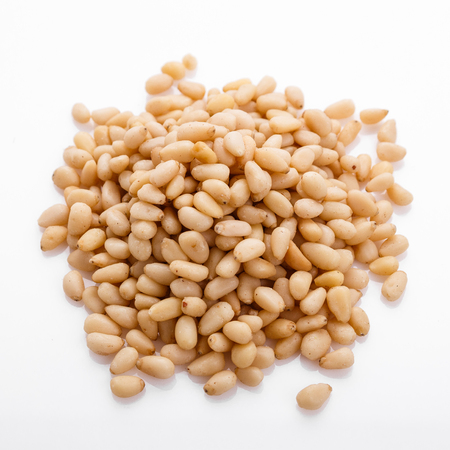 peeled pine nuts on a white acrylic background.の写真素材