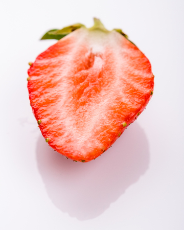 Juicy fresh strawberry on a white acrylic background.の写真素材