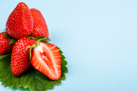 juicy fresh strawberry on a delicately blue background.の写真素材