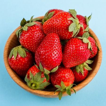juicy fresh strawberry on a delicately blue background.