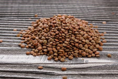 raw lentils on a wooden rustic background.の写真素材