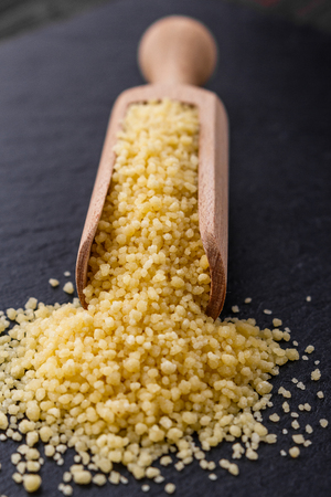 fresh couscous on a dark stone background.の写真素材