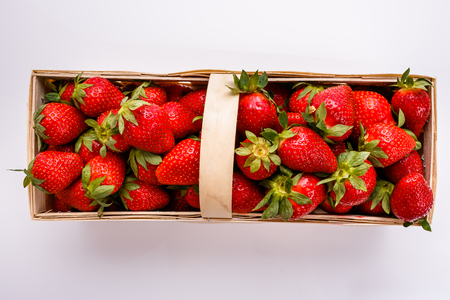 Juicy fresh strawberries in a wooden basket.の写真素材
