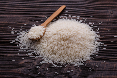 Jasmine rice on a wooden rustic background.の写真素材