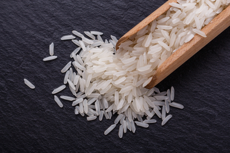 Jasmine rice on a dark stone background.の写真素材