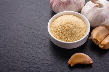 fragrant garlic on a dark stone background.の写真素材