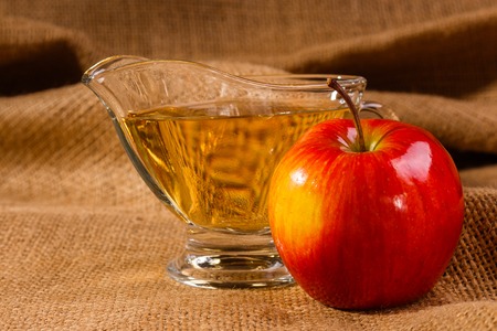 apple vinegar on a wooden rustic background.の写真素材