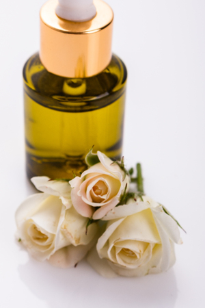 Rose essential oil on a white background.の写真素材