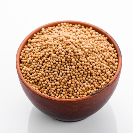 fragrant grains of mustard on a white background.の写真素材