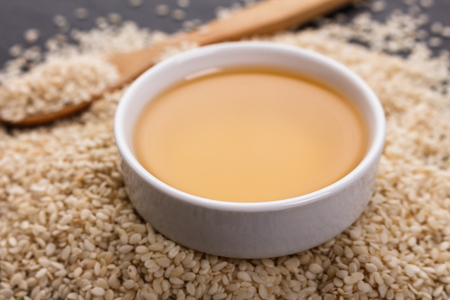 fresh sesame seeds on a rustic background.の写真素材