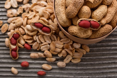 fresh peanuts on a wooden rustic background.の写真素材