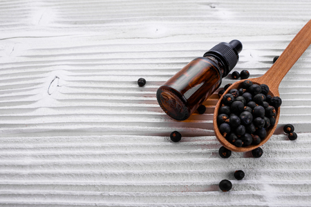 juniper essential oil on a white background.の写真素材