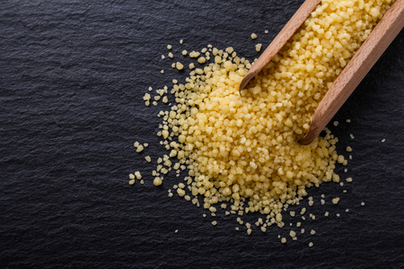 fresh couscous on a dark stone background.の写真素材