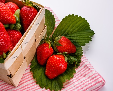 Juicy fresh strawberries in a wooden basket.の写真素材