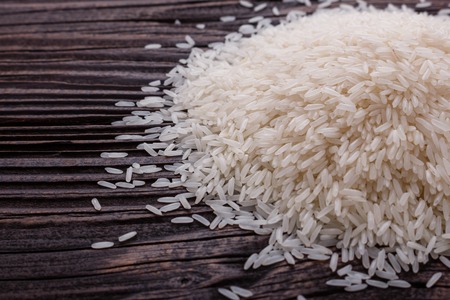 Jasmine rice on a wooden rustic background.の写真素材
