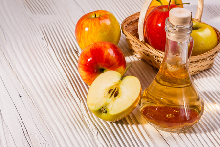 apple vinegar on a wooden rustic background.の写真素材