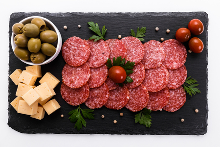 delicious sliced salami on a stone plate.の写真素材