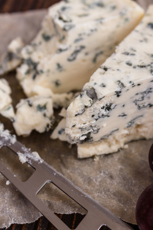 delicious blue cheese on wooden rustic background.の写真素材