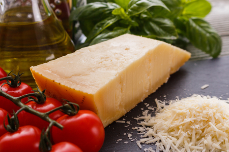 fragrant grated Parmesan on a slate stone slicing board.の写真素材