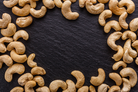 cashew nuts on a dark stone background.の写真素材