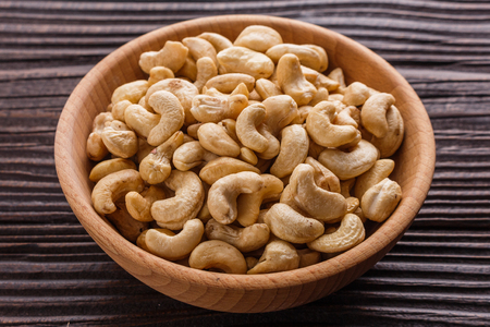 cashew nuts on a rustic wooden background.の写真素材