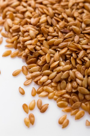 Seeds of golden flax on a white background.の写真素材