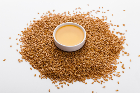 Seeds of golden flax on a white background.の写真素材