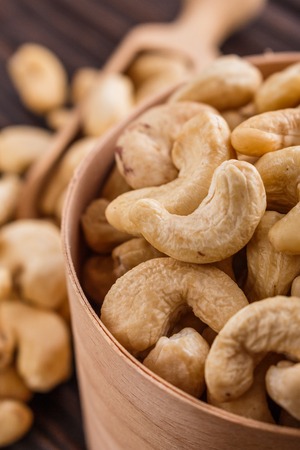 cashew nuts on a rustic wooden background.の写真素材