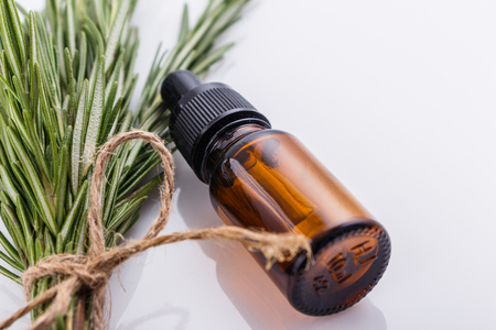 Rosemary essential oil on a white background.の写真素材