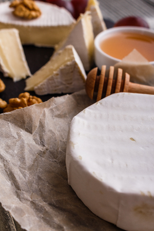 delicious creamy camembert cheese on a wooden rustic background.の写真素材